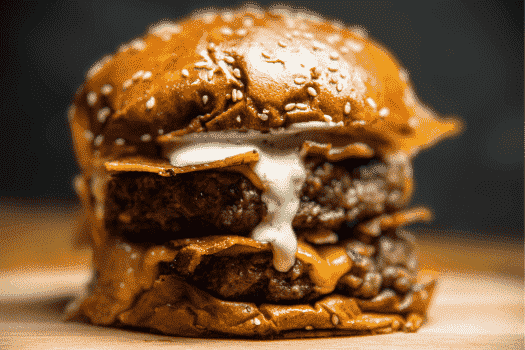 a side angle photo of a burger