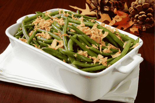 a photo of green beans on a reddish table to show contrast colors