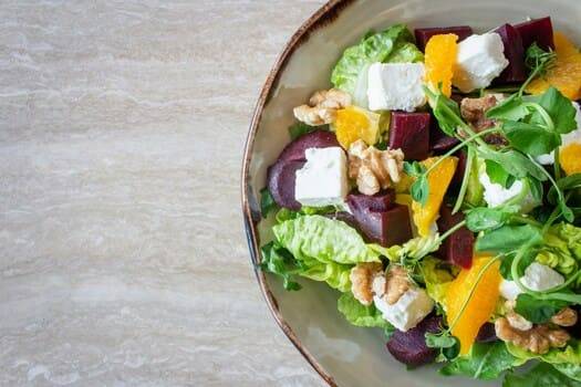 A photo of a salad that follows the food photography tips for styling: highlight the main dish, use fresh ingredients, & keep it simple.