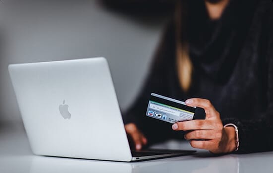 woman at laptop with credit card